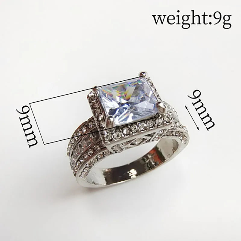 Geometric alloy women's ring in gold and white electroplated finishes on a size chart.