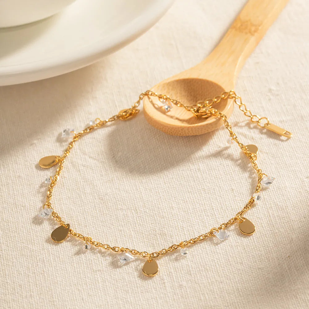 Women's stainless steel anklet with a geometric water drop pendant and a tassel detail.