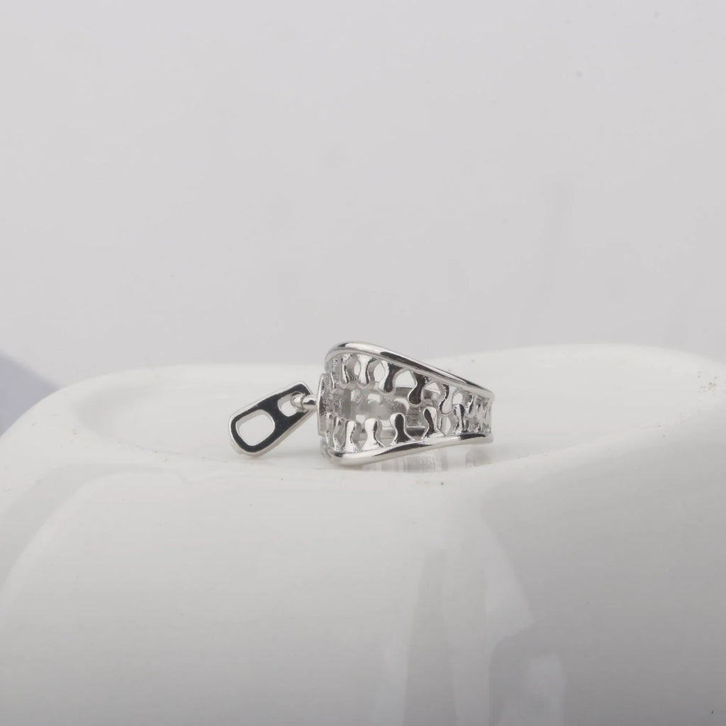 Copper geometric bone clip earrings with linear design on a white background.