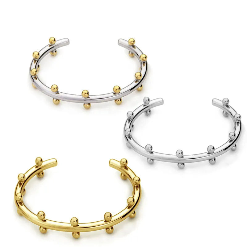 C-shaped stainless steel jewellery beads with rivet texture in gold, steel, and steel gold colours.