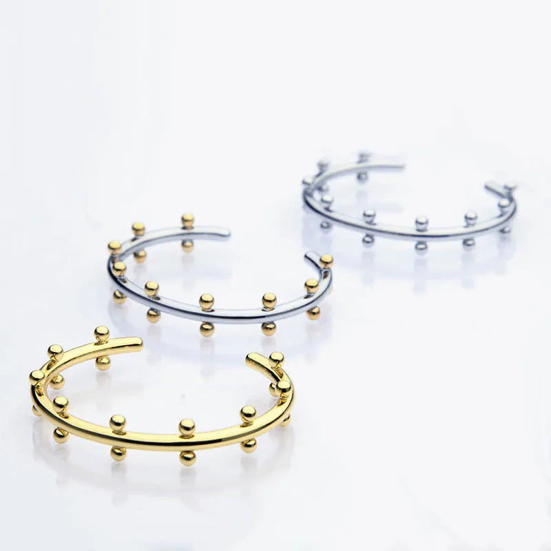 C-shaped stainless steel jewellery beads with rivet texture in gold, steel, and steel gold colours.