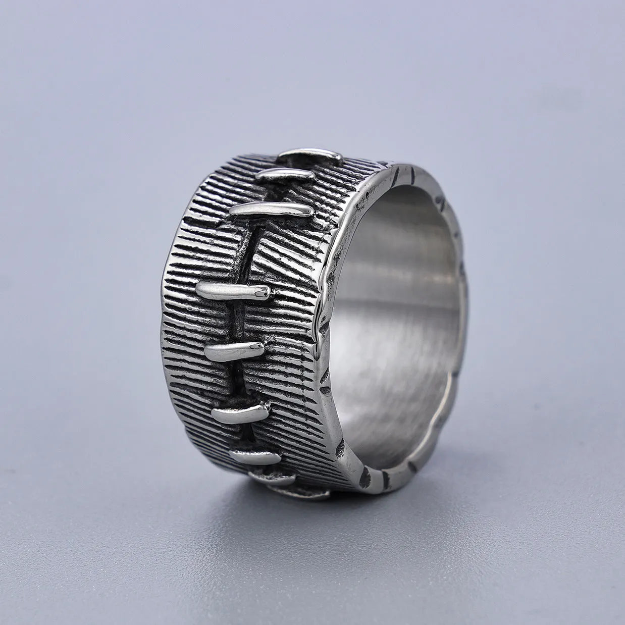 Titanium steel geometric U-shaped double ring in retro black colour, showing stitched design detail.