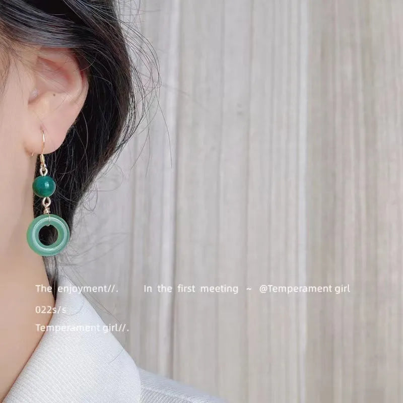 Green geometric peace buckle earrings with 14K gold plating on a zinc alloy base.