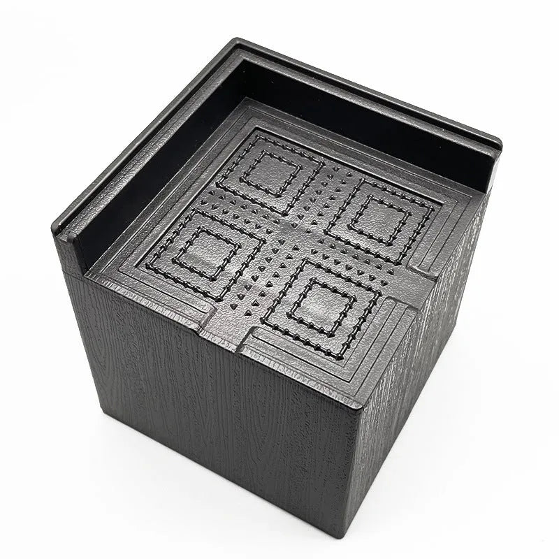 Four black plastic bed riser feet for increasing furniture height and creating storage space