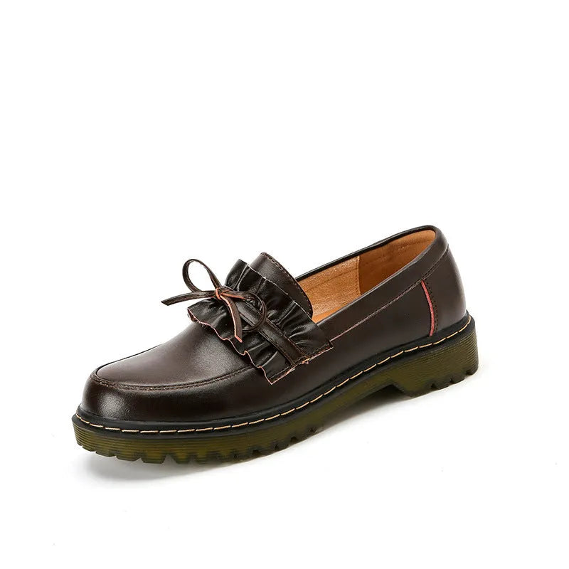 Women's black leather shoes with a chunky heel and round toe, showing the low-top design and cowhide upper.