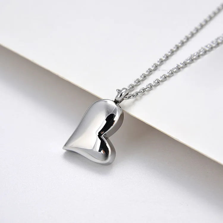 Curved peach heart stainless steel pendant necklace with silver electroplated finish