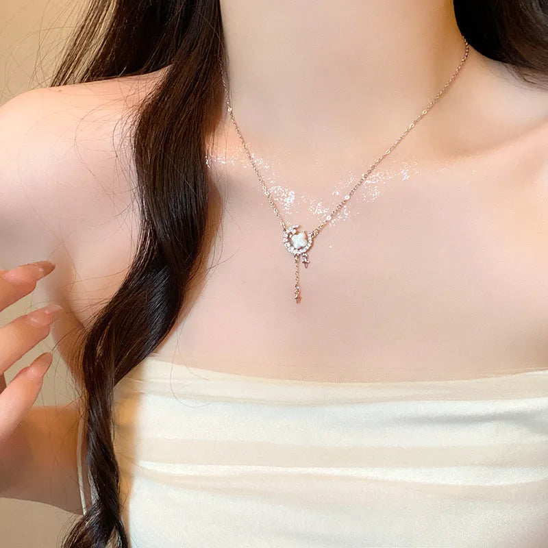 Women's gold necklace with star and moon pendant featuring zirconium crystal treatment
