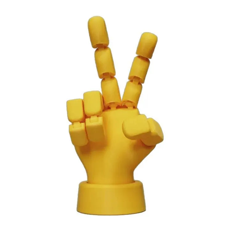Yellow PLA hand ornament figurine with movable joint on a display surface.