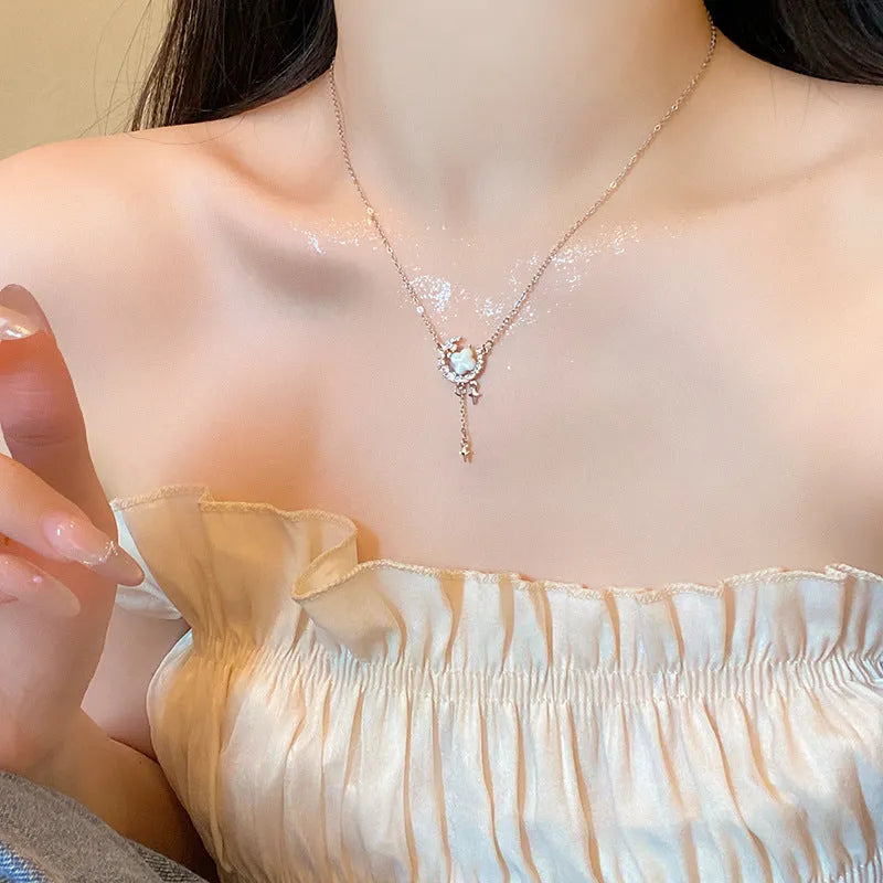 Women's gold necklace with star and moon pendant featuring zirconium crystal treatment