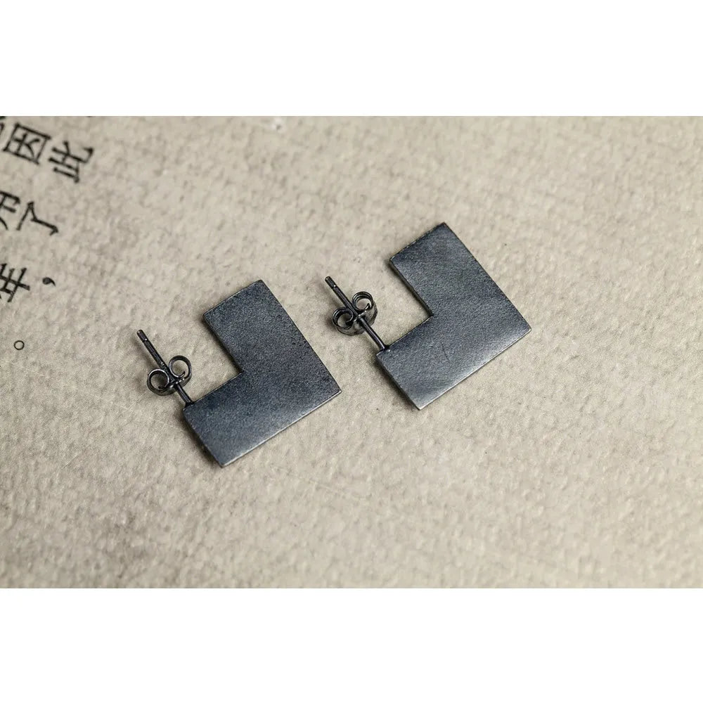 Oxidation black geometric square sterling silver earring ring on a 16mm scale.