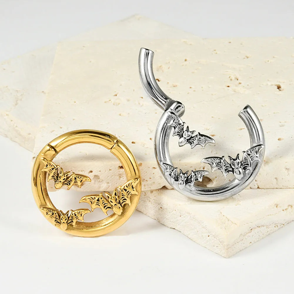 A pair of stainless steel fashion earrings with an intricate totem pattern design in a silver-toned finish.