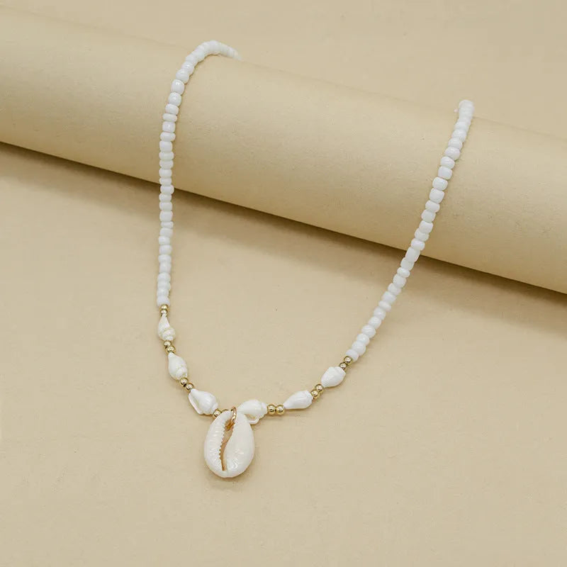 White conch shell necklace with mother-of-pearl pendant on regular chain