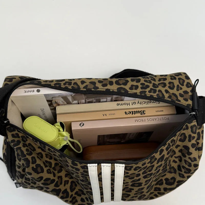 Leopard print sports style shoulder messenger bag with cross-body strap and large main compartment