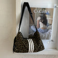Leopard print sports style shoulder messenger bag with cross-body strap and large main compartment