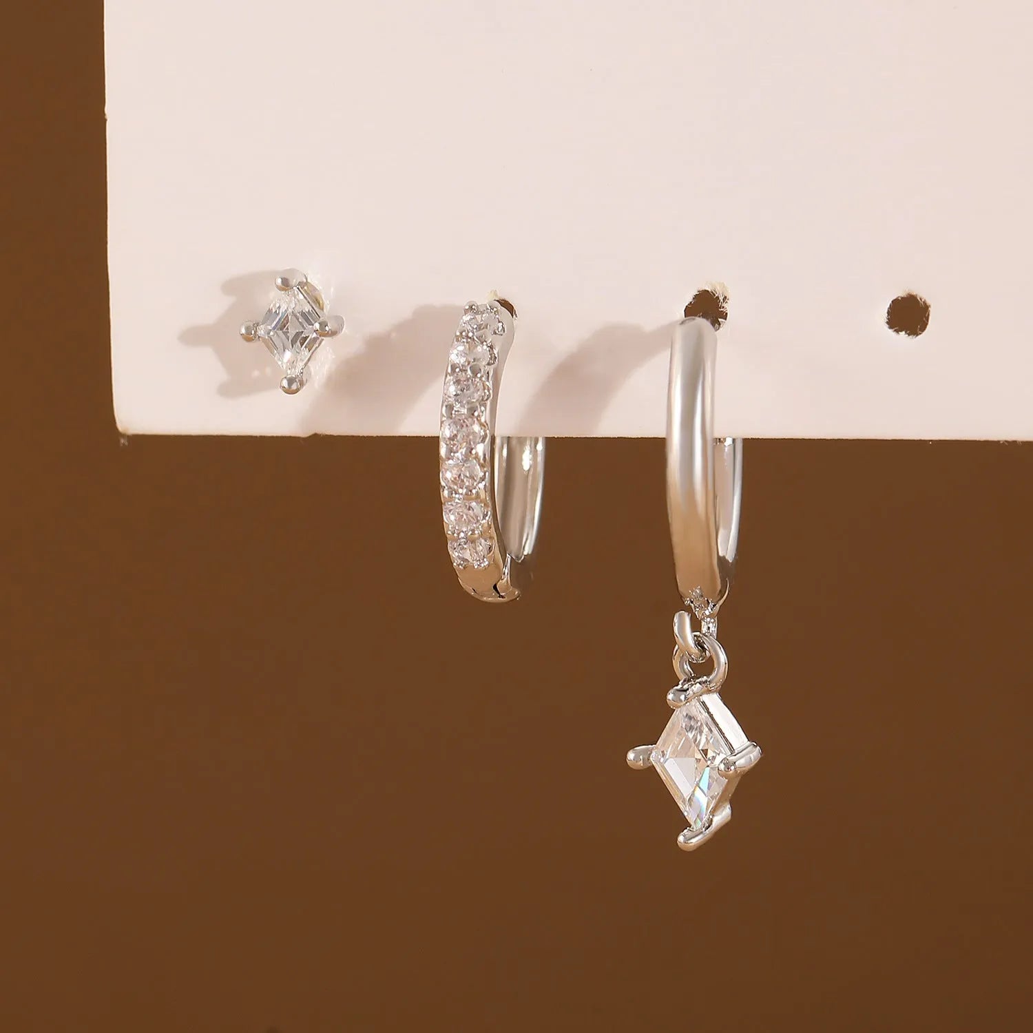 Ladies three-piece geometric earring set with inlaid zircon in gold or white finish
