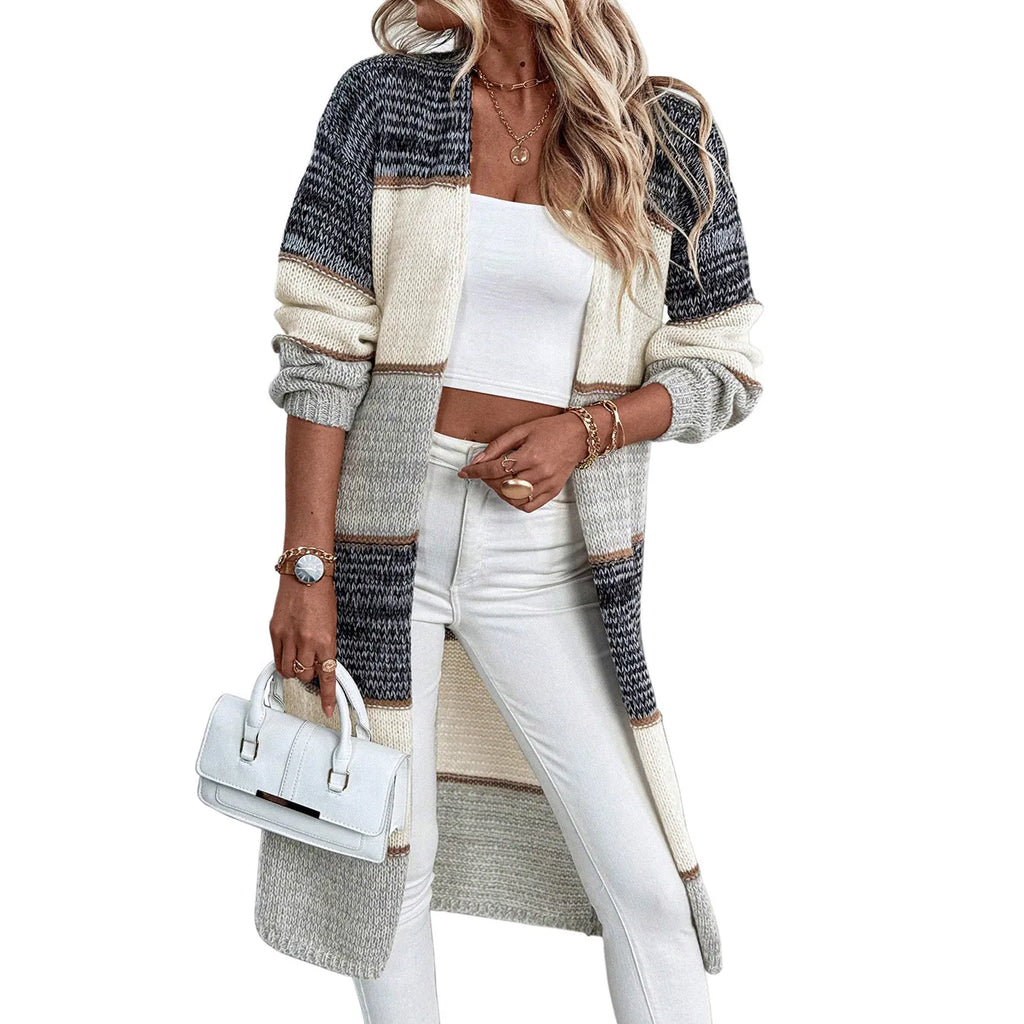 Grey striped women's long sleeve knitted cardigan on a hanger, showing loose fit.