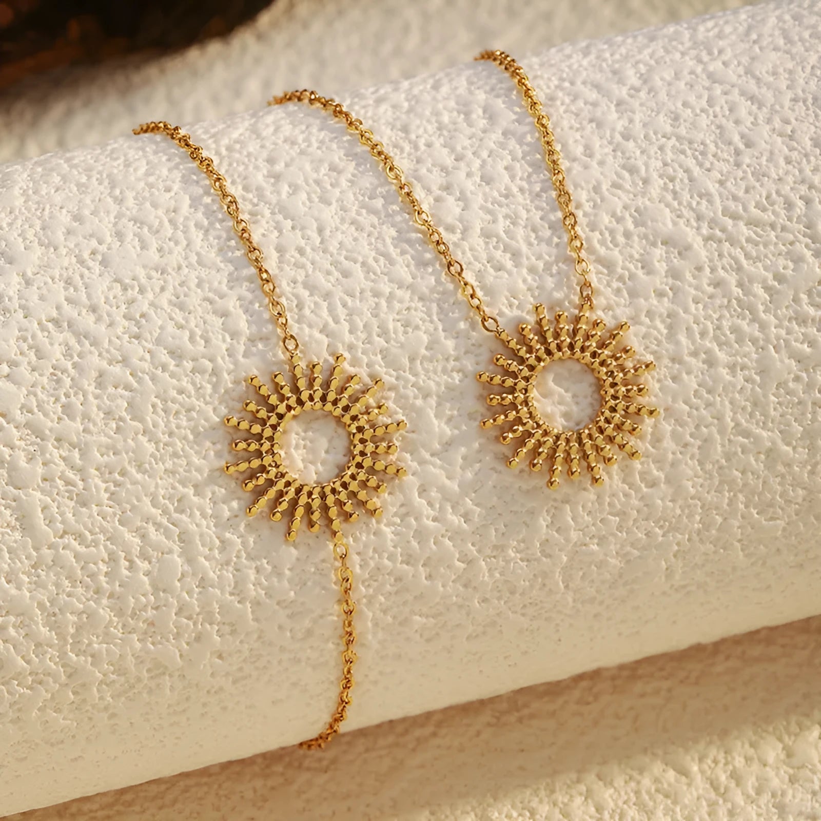 Gold tone geometric jewellery set with sun motif including necklace and bracelet for women