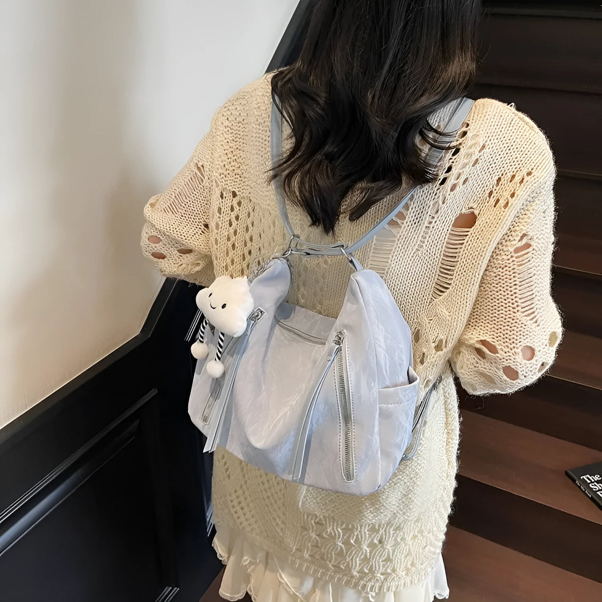 Soft black PU ladies fashion backpack with pendant, shown alongside blue, silver, and milky white colour options.