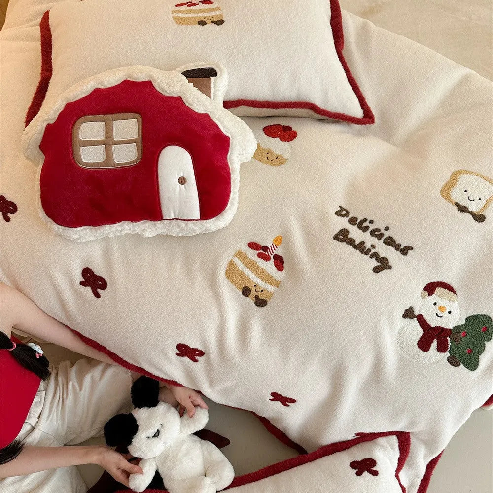 Winter Christmas cartoon snowman print bedding four-piece set on a single bed, showing duvet cover, pillowcases, and sheet.