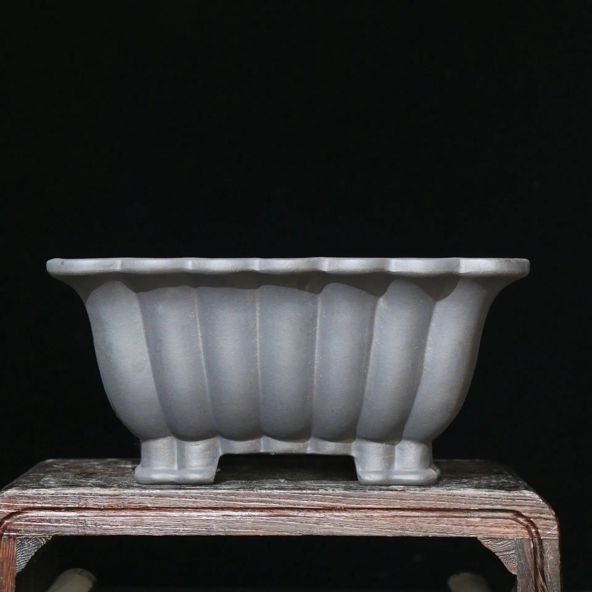 Square purple sand ceramic bonsai pot with warp device on a desktop.
