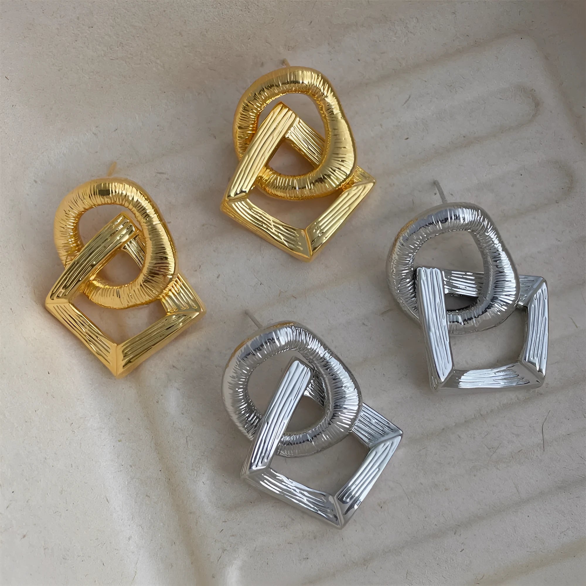 Gold and silver geometric pendant earrings with a 3.4cm retro design