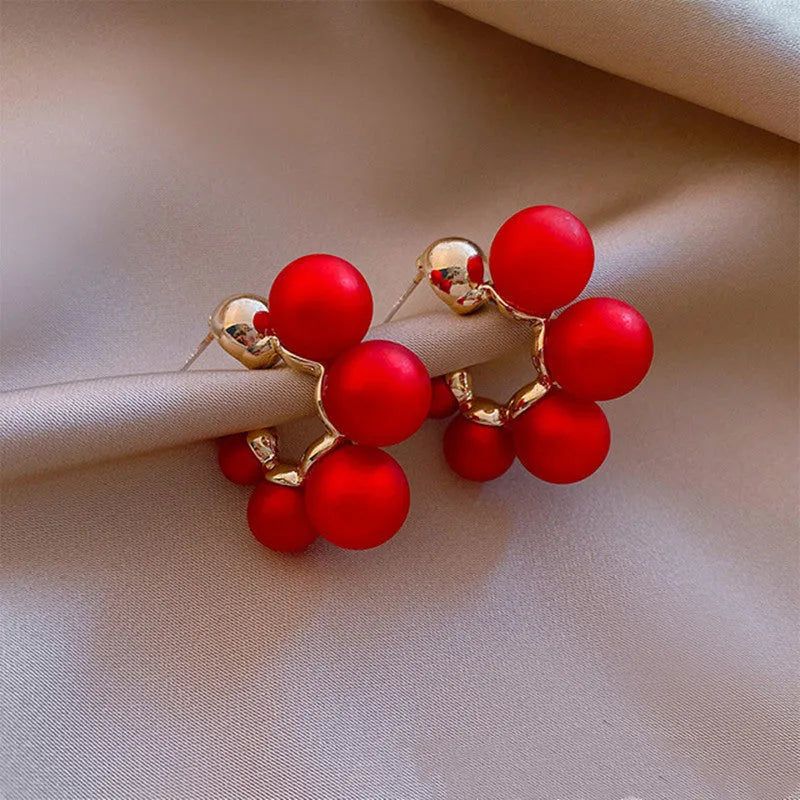 Red bell-shaped alloy drop earrings with gold-tone finish, approximately 2-3 cm length