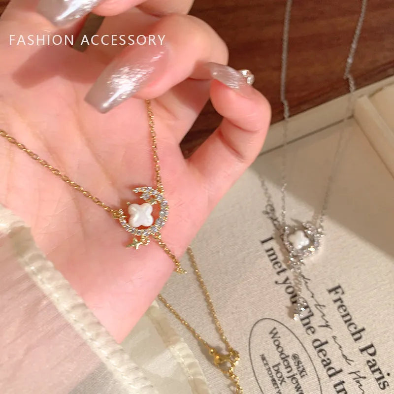 Women's gold necklace with star and moon pendant featuring zirconium crystal treatment
