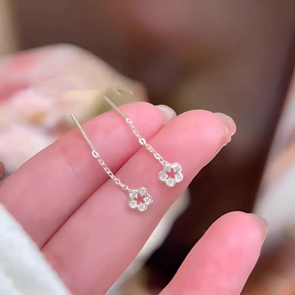 Pair of silver-coloured alloy flower stud earrings with hollow petal design