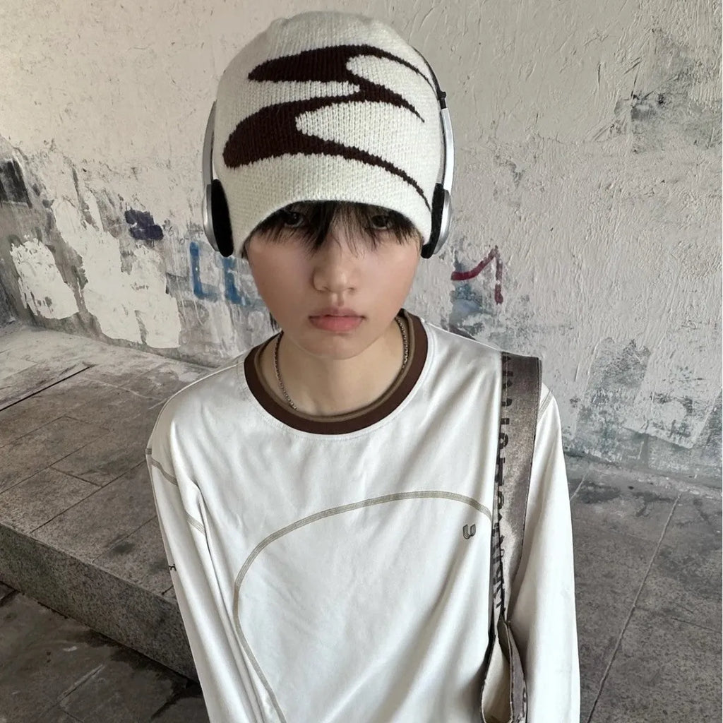 Acrylic knitted beanie hat in black, shown on a model, suitable for winter wear.