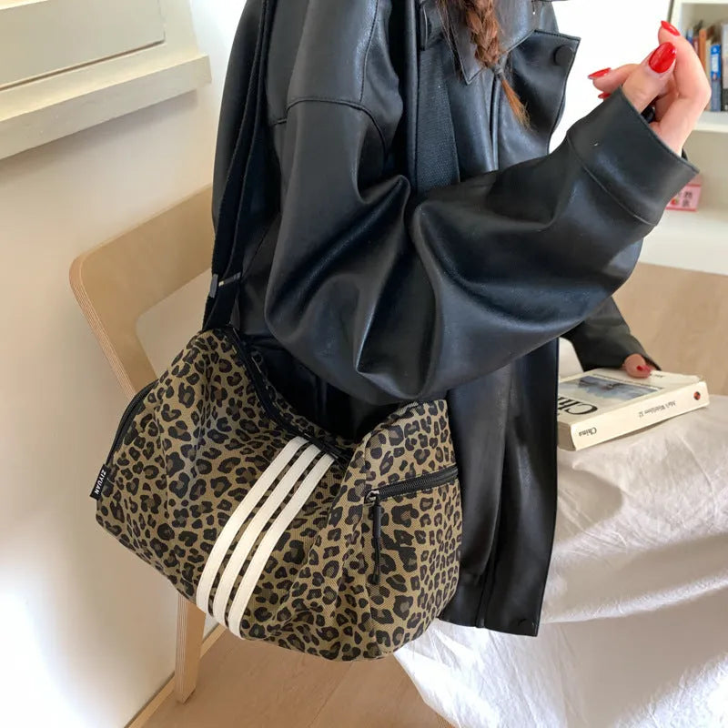 Leopard print sports style shoulder messenger bag with cross-body strap and large main compartment
