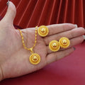 Gold-plated three-piece jewellery set with floral pendant necklace, matching ring and earrings