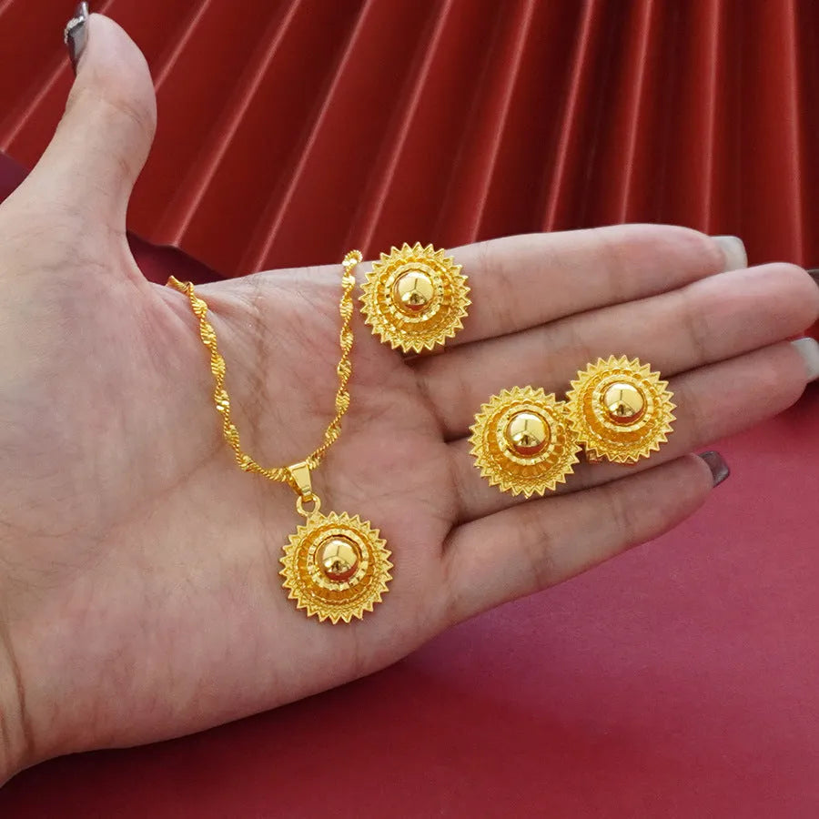 Gold-plated three-piece jewellery set with floral pendant necklace, matching ring and earrings