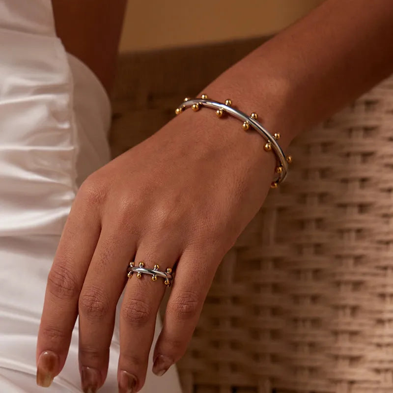 C-shaped stainless steel jewellery beads with rivet texture in gold, steel, and steel gold colours.