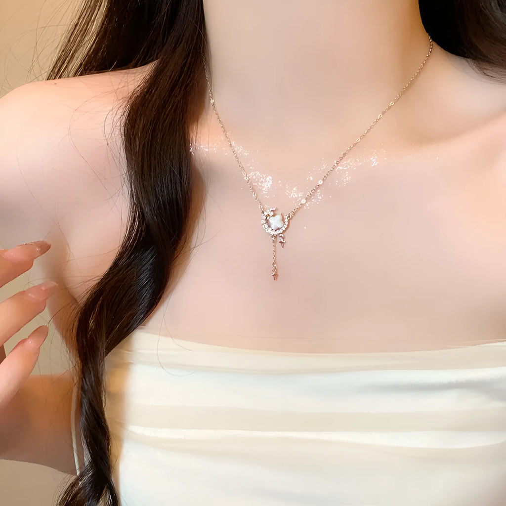 Women's gold necklace with star and moon pendant featuring zirconium crystal treatment
