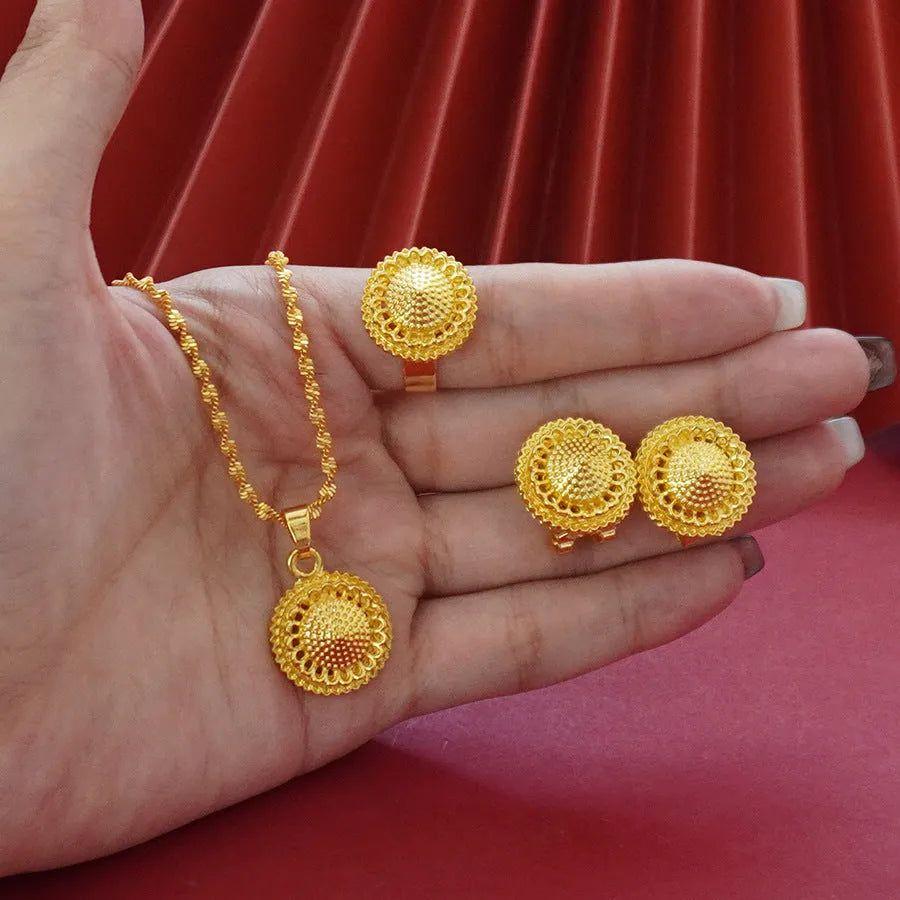Gold-plated three-piece jewellery set with floral pendant necklace, matching ring and earrings