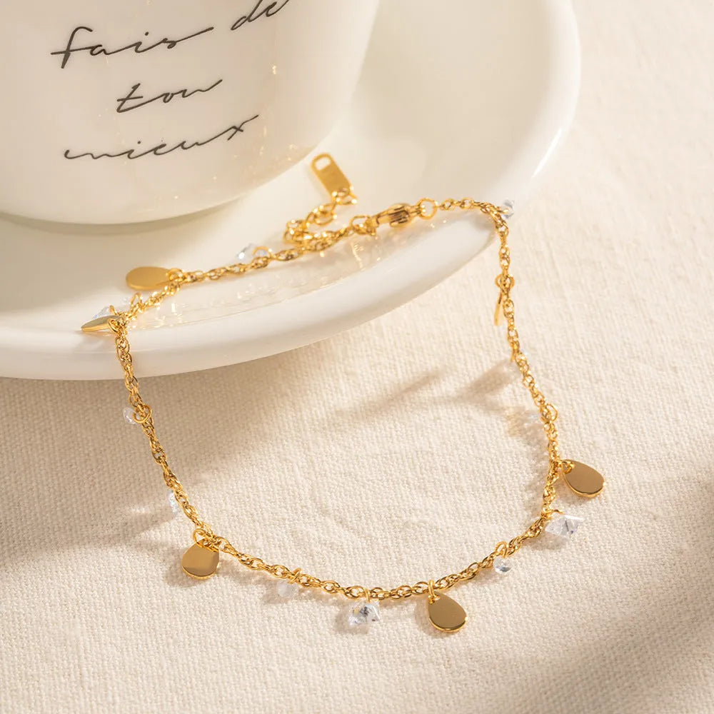Women's stainless steel anklet with a geometric water drop pendant and a tassel detail.
