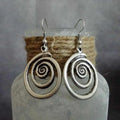 Silver alloy geometric spiral earrings with distressed finish measuring 2.6cm wide by 5cm long