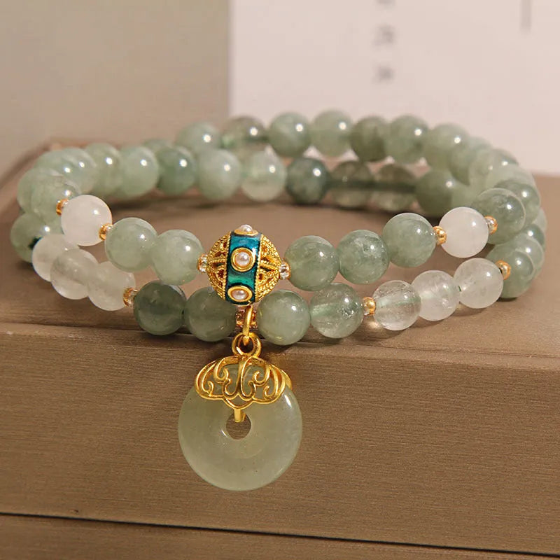 Women's green double-layer crystal bracelet with a peace buckle clasp and rhinestone details.