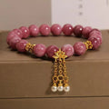 Pink lotus tassel and pearl pendant bracelet with pink white crystal beads in a New Chinese style.