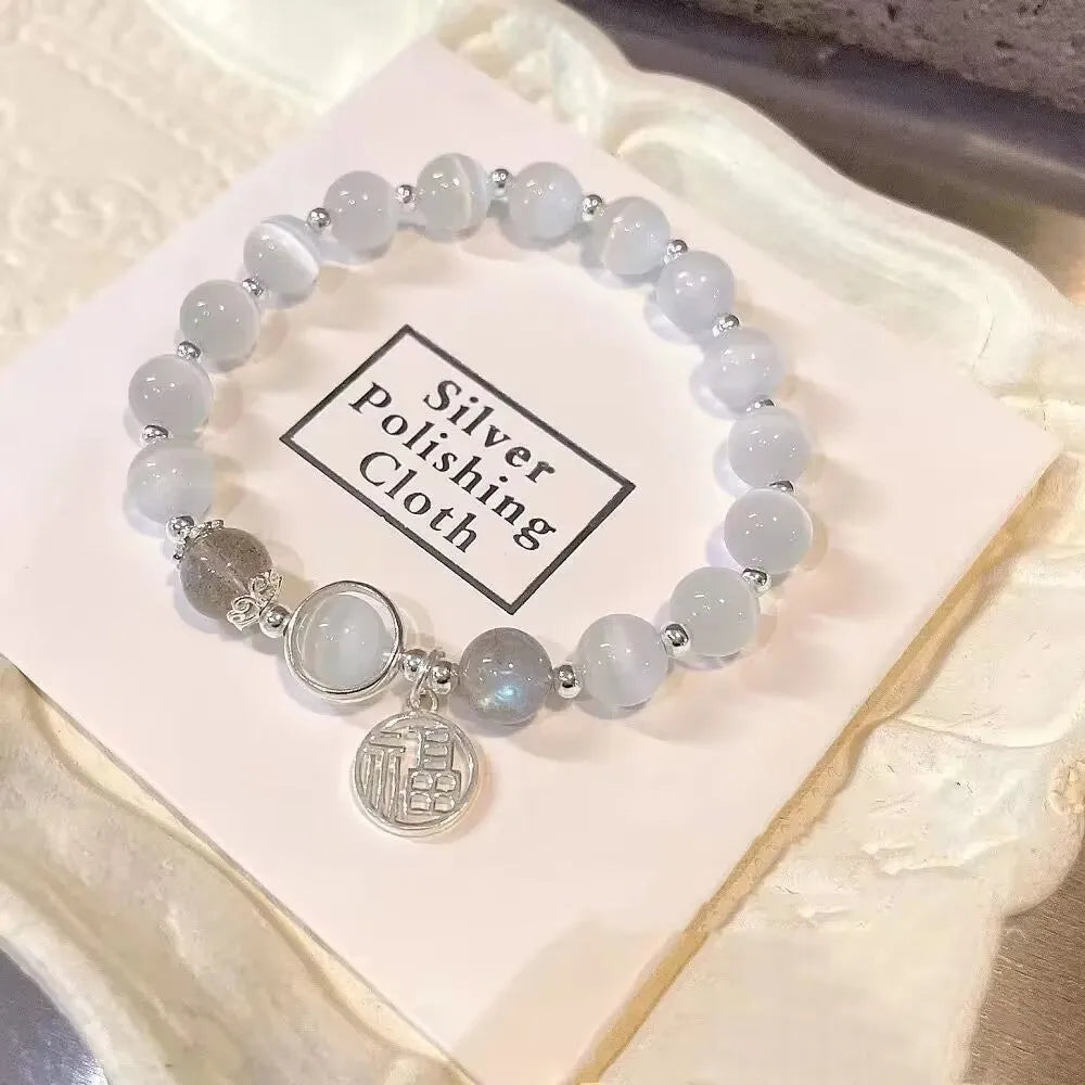 Women's handcrafted glass bead bracelet with butterfly design elements and grey colour tones