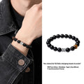 Men's obsidian and pure silver bracelet with six-word mantra prayer wheel design