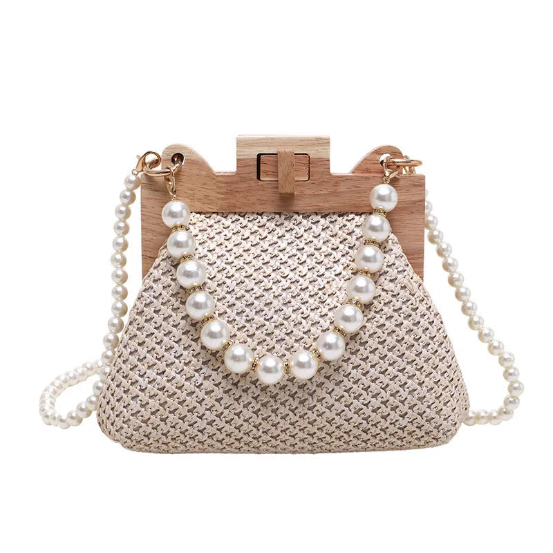 Women's straw shoulder bag with pearl chain detail and multiple zipper compartments in neutral colour