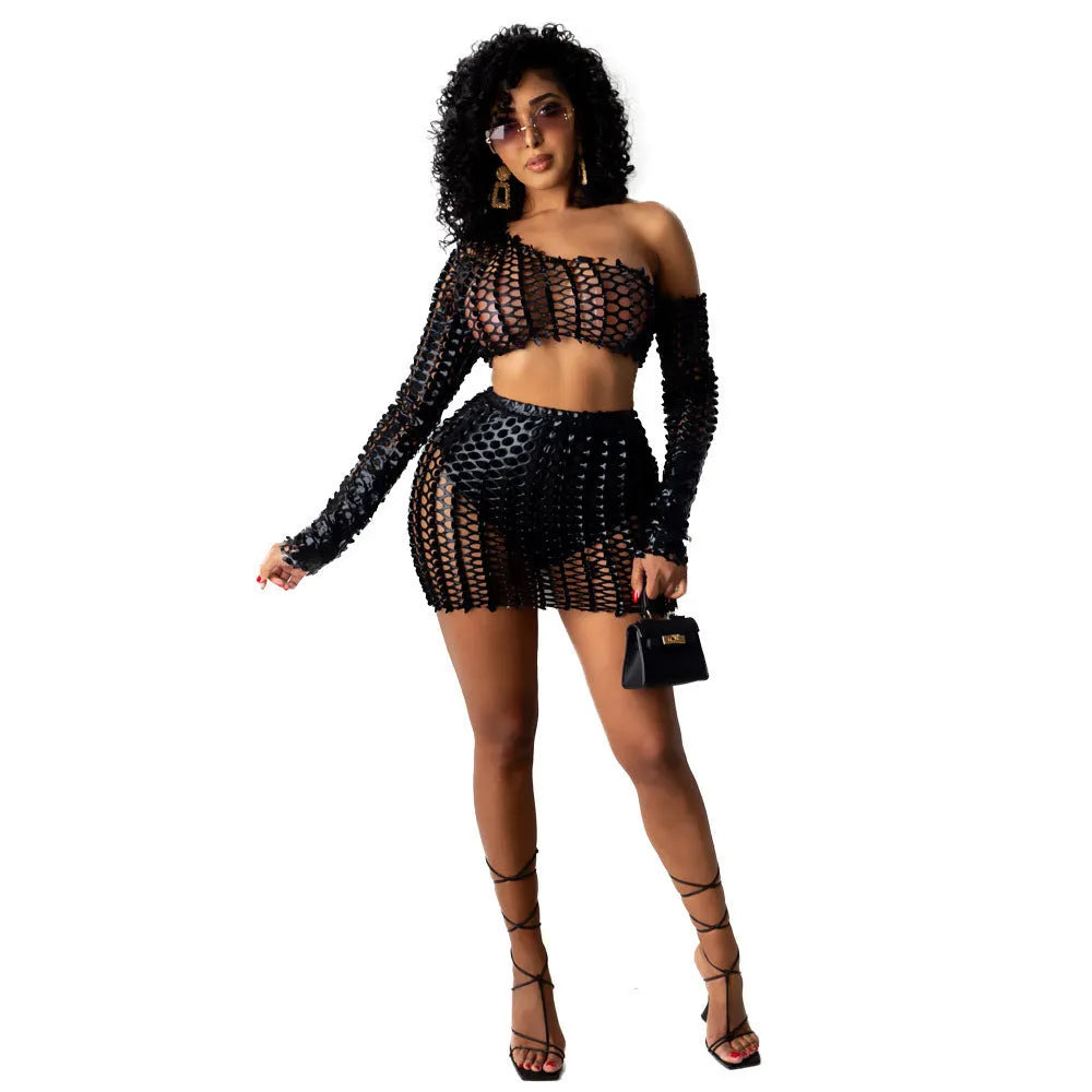Women's sleeveless hollow-out mesh two-piece dress set in black, showing top and short skirt with splicing design.