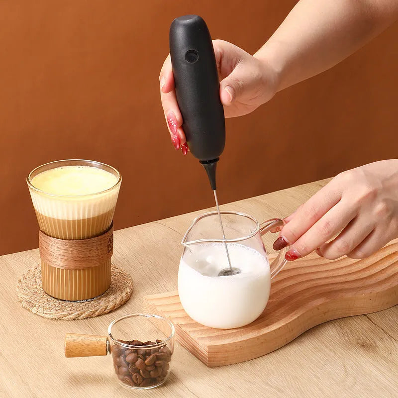 Hand-held electric milk frother blender in black or white colour with modern simplicity design