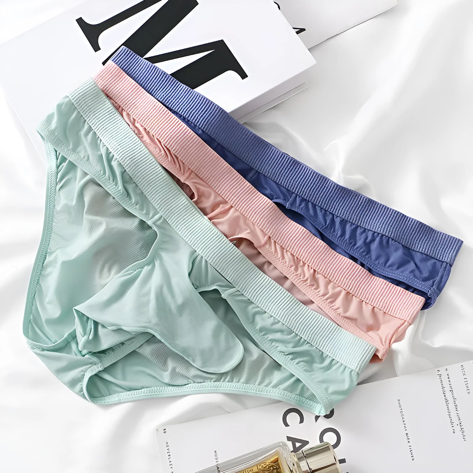 Men's low waist ice silk briefs in black, gray, light green, pink, and purplish blue colours.