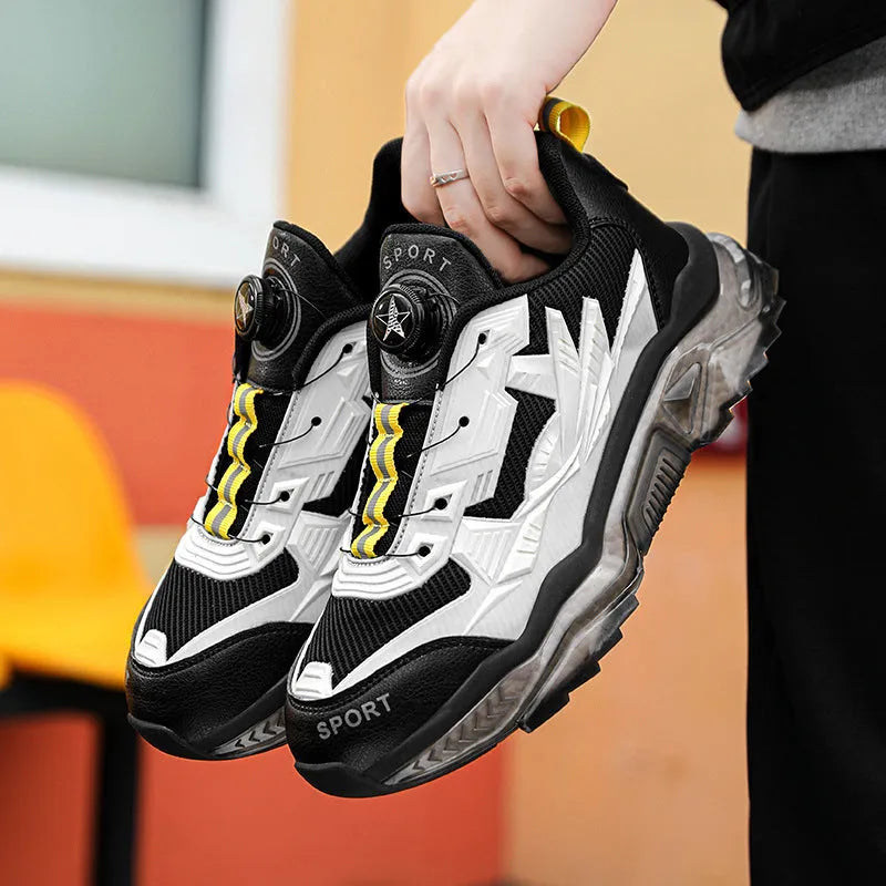 Men's black casual sneakers with rotating button closure and mesh upper on rubber sole.