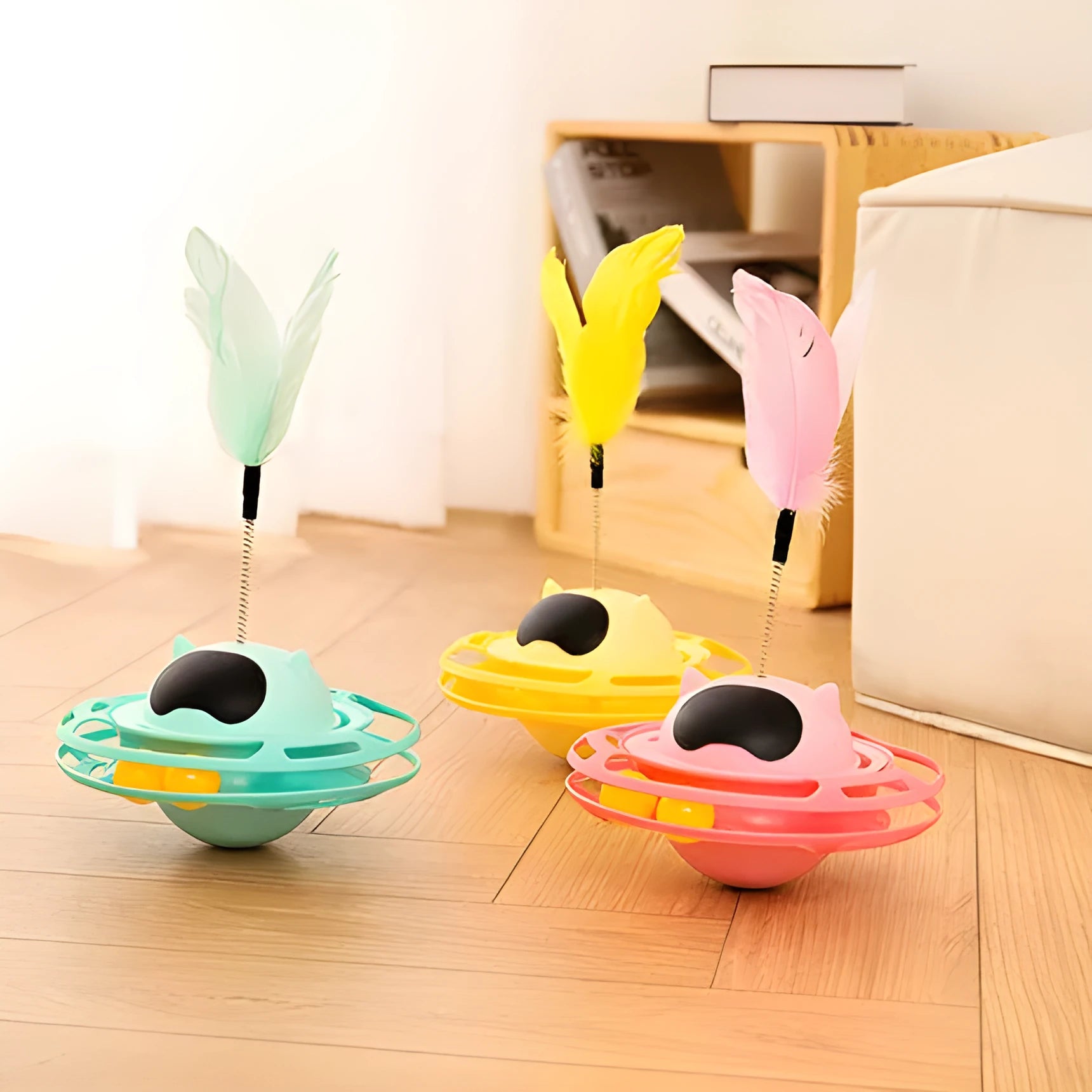 Pink cat tumble turntable toy with attached cat stick for interactive play
