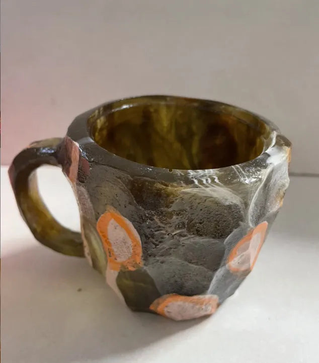 Resin mineral crystal coffee mug with handle in purple colour, showing 3D texture.