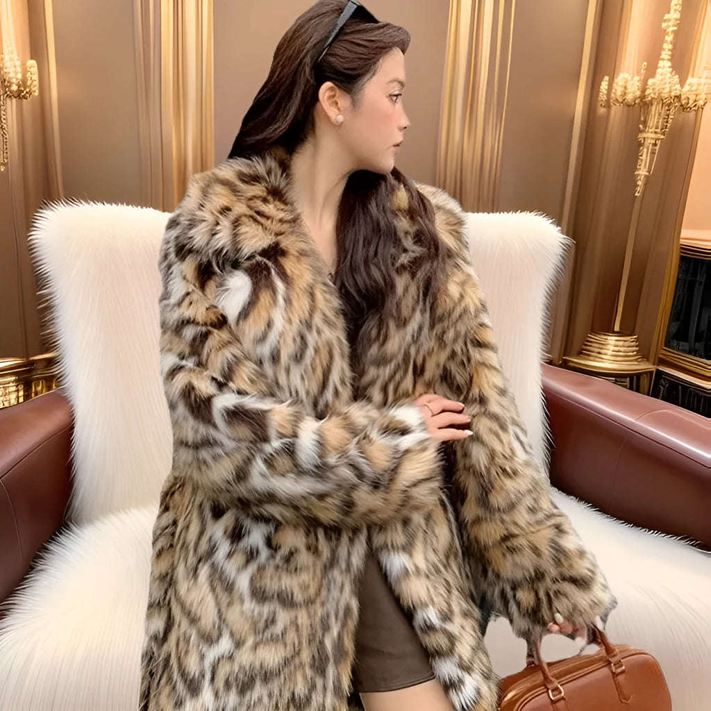 Long grey faux fur coat with a large fur collar and pockets on a model.