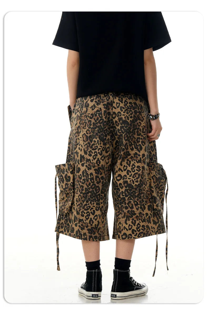 Leopard print cotton cropped trousers with a high waist and straight leg on a hanger